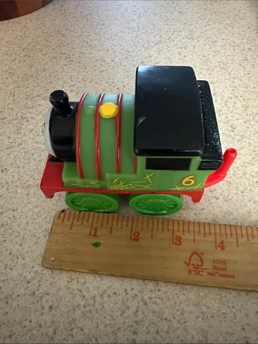 Green Percy the Small Engine toys and cargo cars from Thomas & Friends.